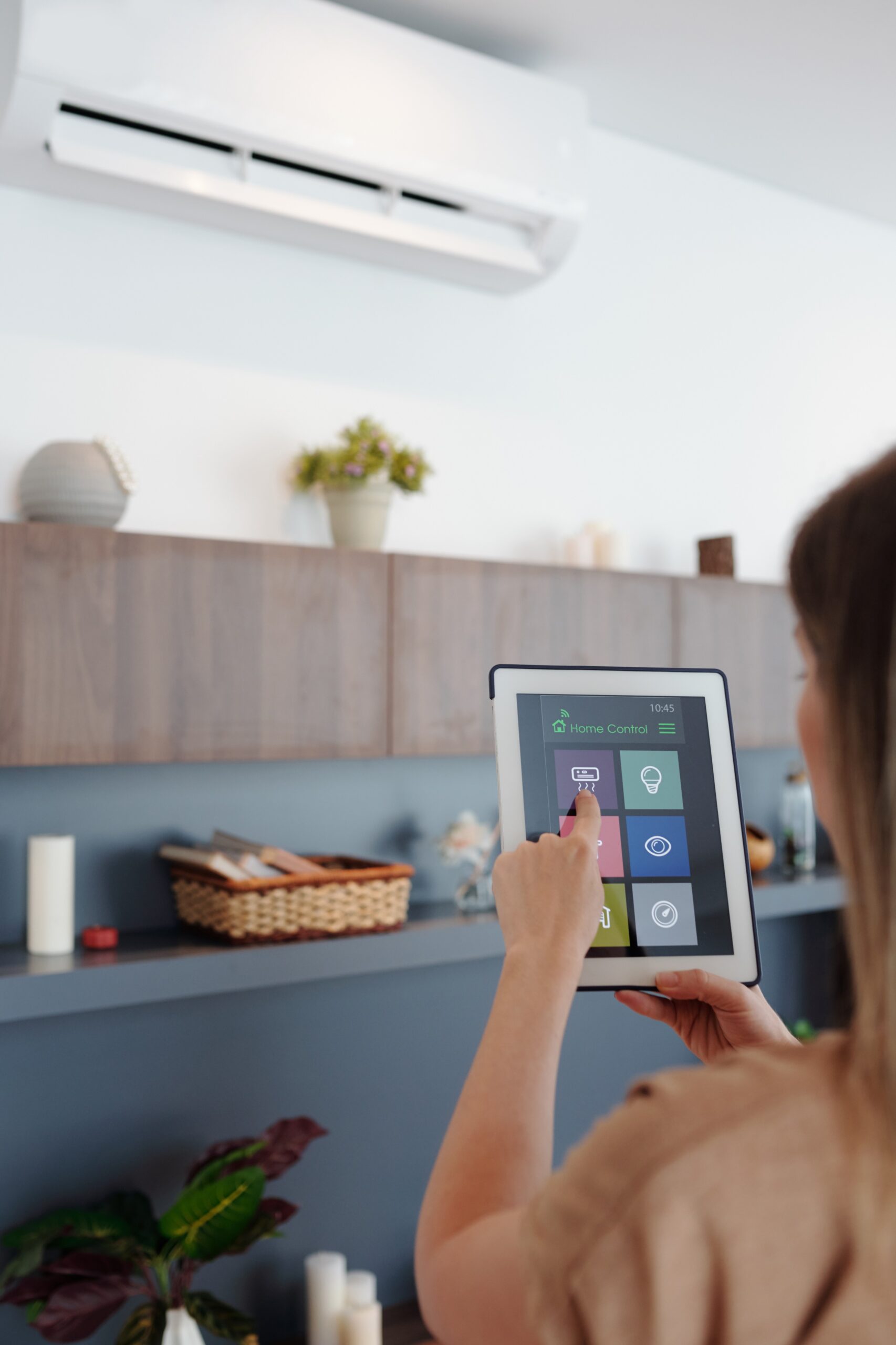 young-woman-using-smartphone-home-application-tablet-computer-when-setting-temperature-her-apartment (1)